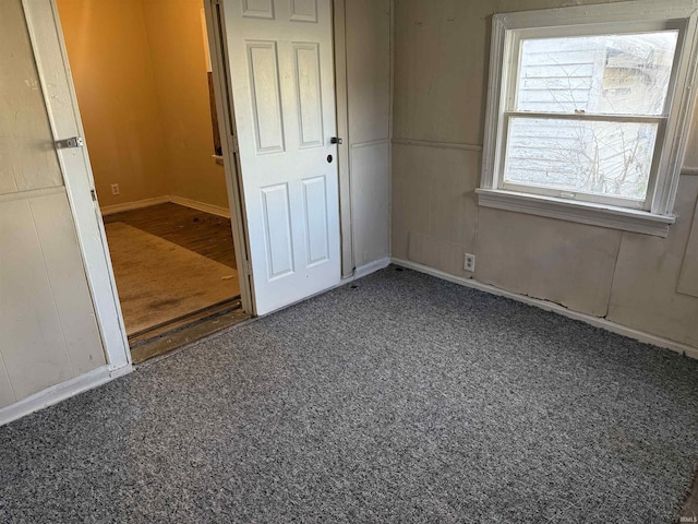 unfurnished bedroom with dark carpet