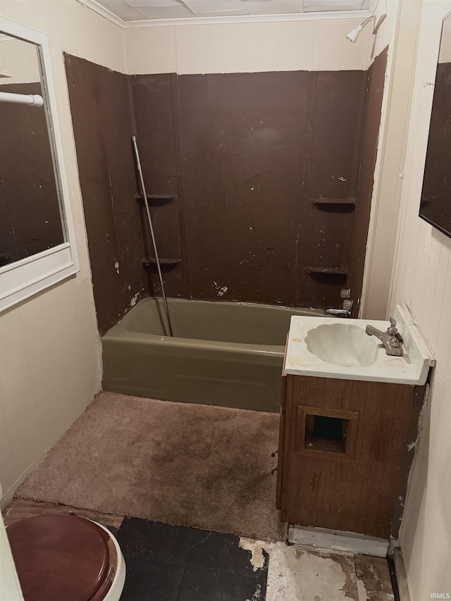 full bathroom featuring vanity, toilet, washtub / shower combination, and wooden walls