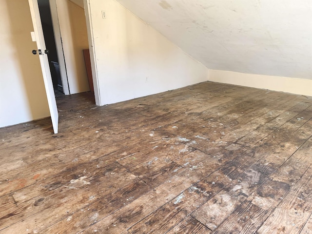 additional living space with dark wood-type flooring and lofted ceiling