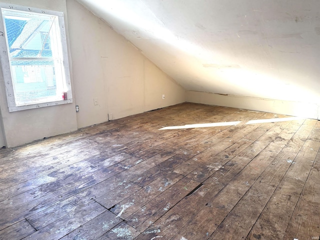 additional living space featuring wood-type flooring and lofted ceiling