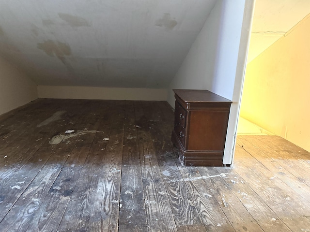 bonus room with dark hardwood / wood-style floors and lofted ceiling