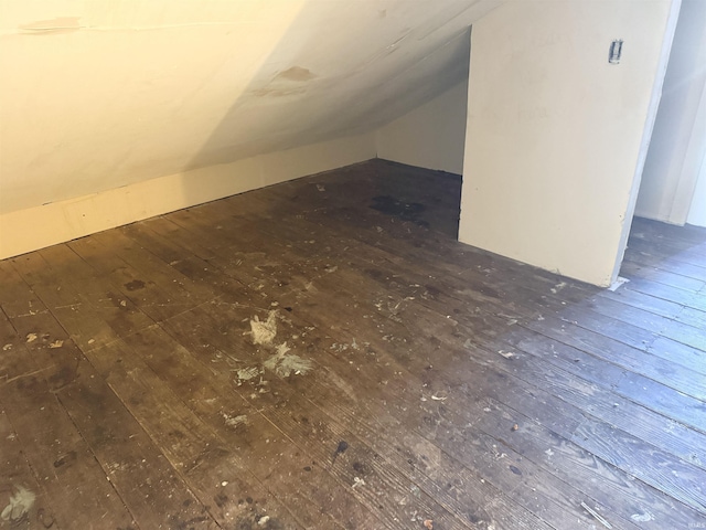 bonus room with dark hardwood / wood-style flooring and lofted ceiling