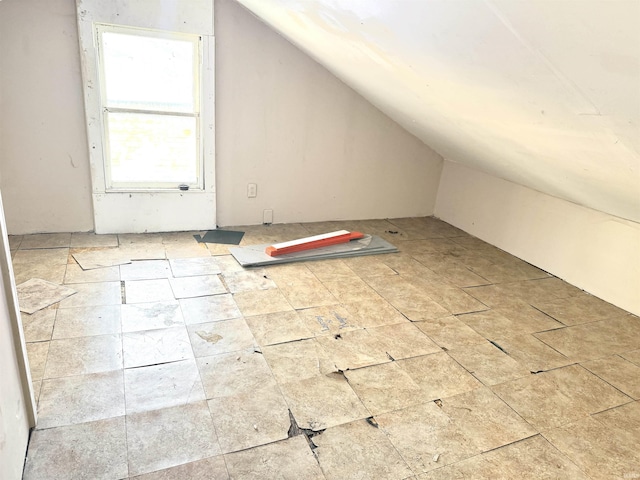 additional living space featuring vaulted ceiling