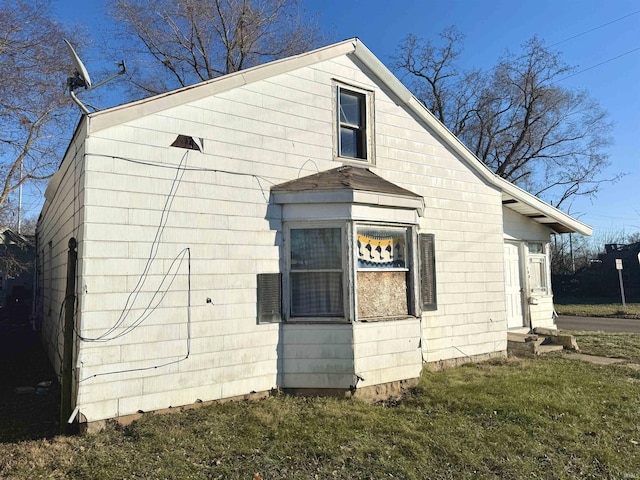 view of home's exterior with a lawn