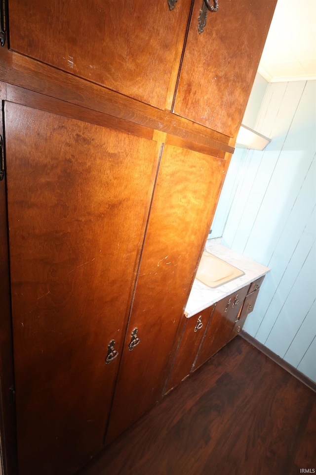 room details with wood-type flooring and wooden walls