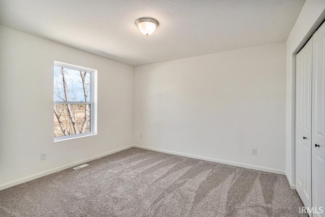 unfurnished bedroom with carpet and a closet