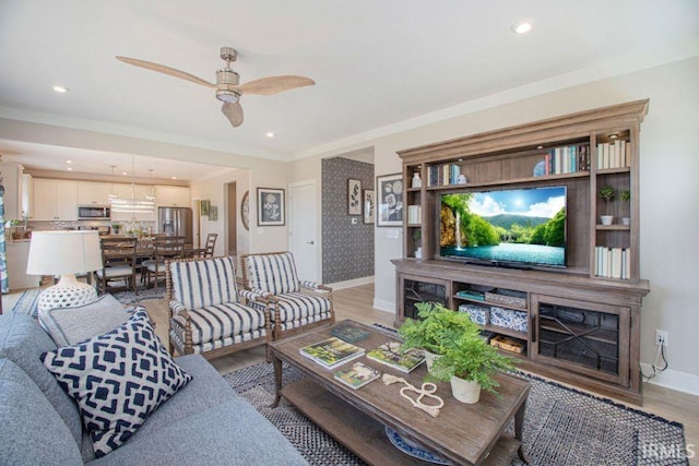 living room with ceiling fan and light wood-type flooring