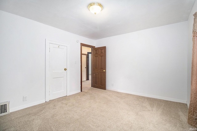 spare room with light colored carpet