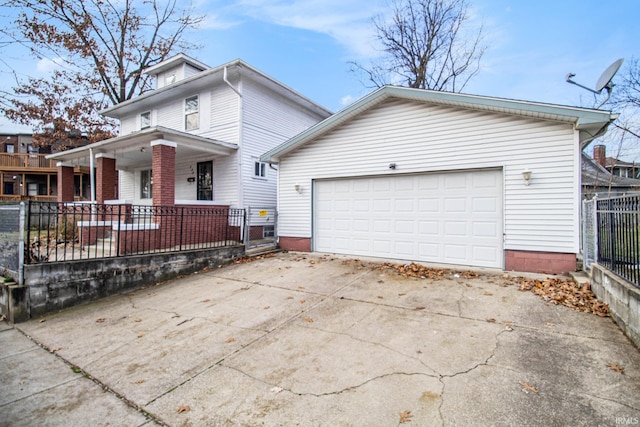 view of front of property with covered porch and a garage