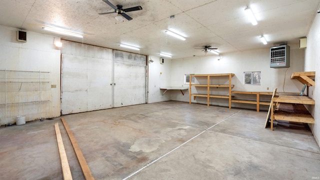 basement with ceiling fan and heating unit