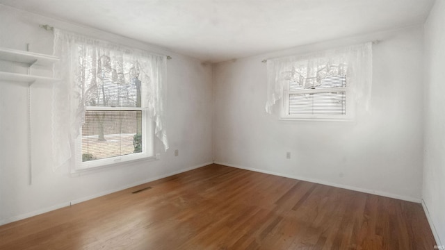 spare room with wood-type flooring