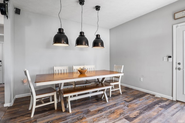 dining area featuring dark hardwood / wood-style floors and a textured ceiling