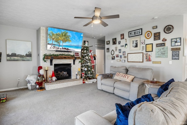 carpeted living room featuring ceiling fan, a textured ceiling, and a brick fireplace