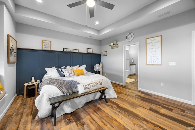 bedroom with ceiling fan, dark hardwood / wood-style flooring, and ensuite bathroom