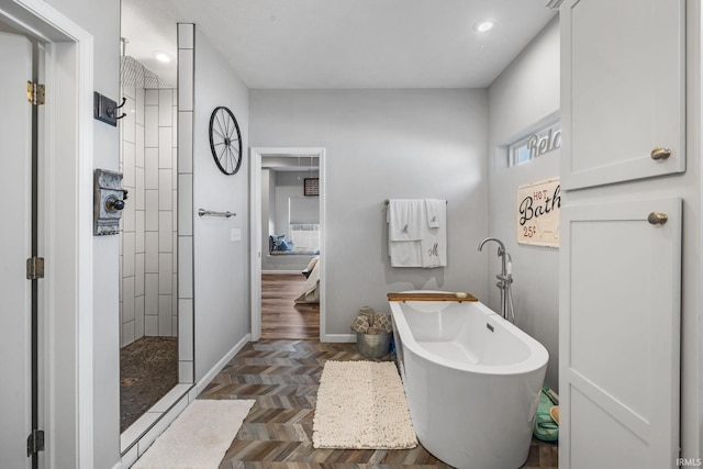 bathroom featuring parquet flooring and separate shower and tub