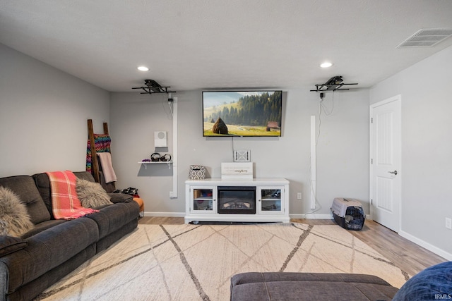 living room featuring hardwood / wood-style flooring and ceiling fan