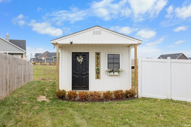 view of outbuilding with a lawn