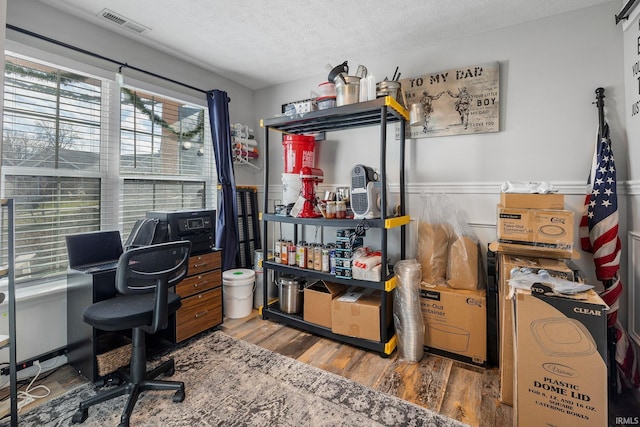 office with a textured ceiling and hardwood / wood-style flooring