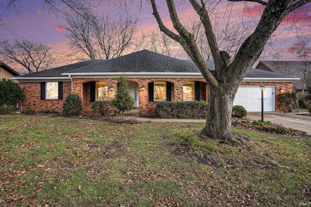 ranch-style home with a yard and a garage