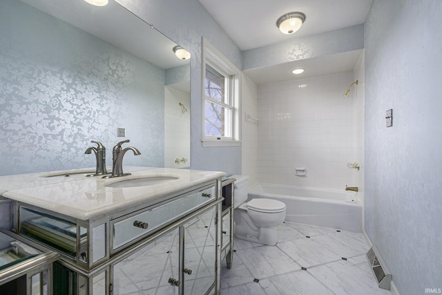 full bathroom with vanity, toilet, and tiled shower / bath