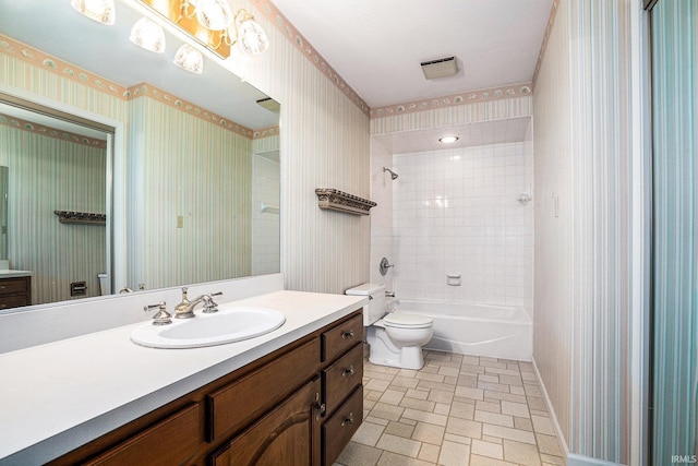 full bathroom featuring vanity, toilet, and tiled shower / bath combo