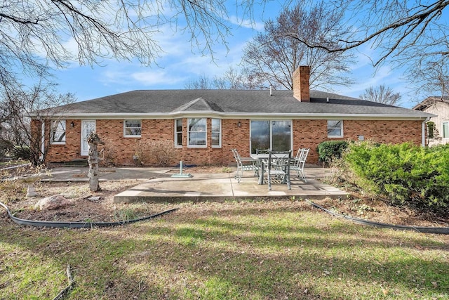 rear view of property with a lawn and a patio