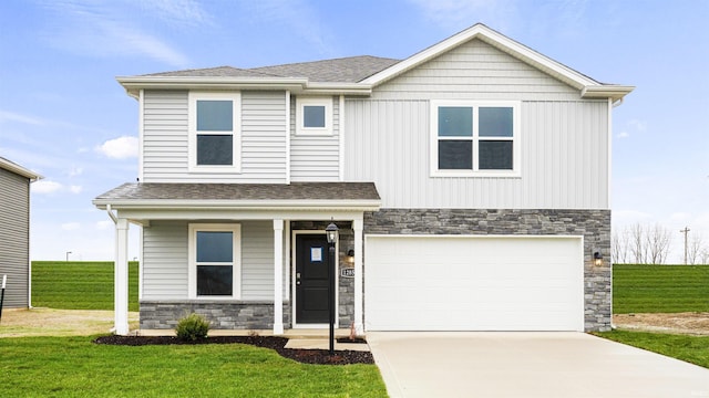 view of front of property with a front yard and a garage