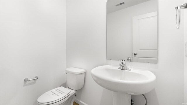 bathroom with toilet and sink