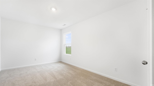 empty room featuring light colored carpet