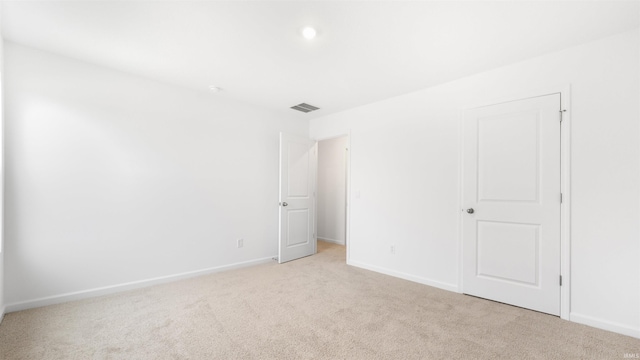 unfurnished room with light colored carpet