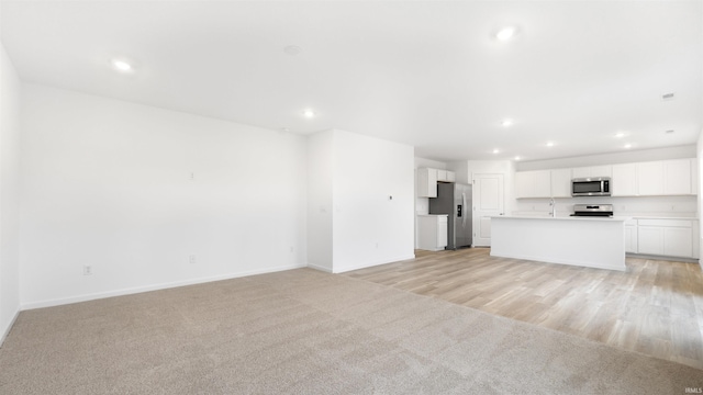 unfurnished living room with light hardwood / wood-style floors