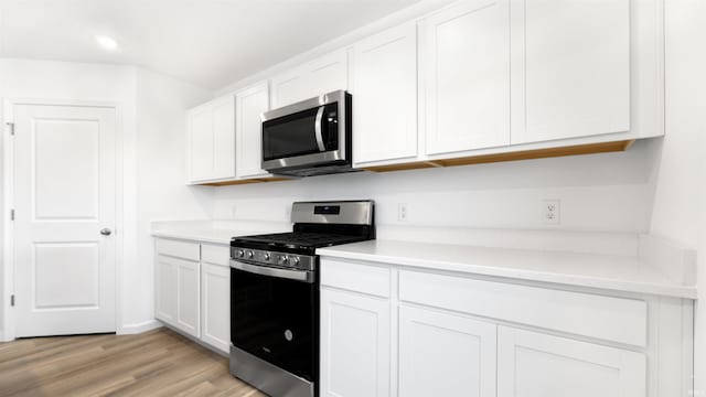 kitchen featuring white cabinetry, light hardwood / wood-style floors, and appliances with stainless steel finishes