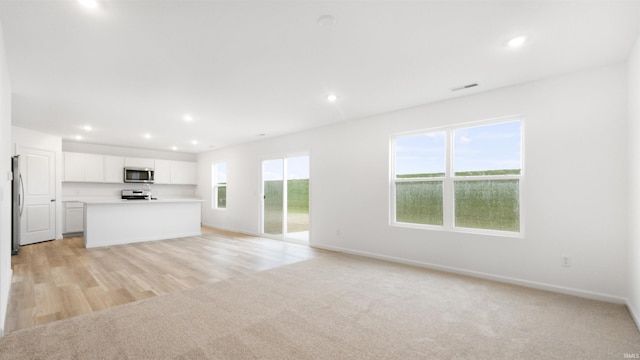 unfurnished living room with light hardwood / wood-style flooring