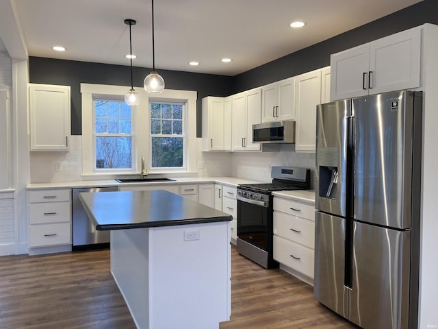 kitchen with white cabinets, dark hardwood / wood-style floors, sink, and stainless steel appliances