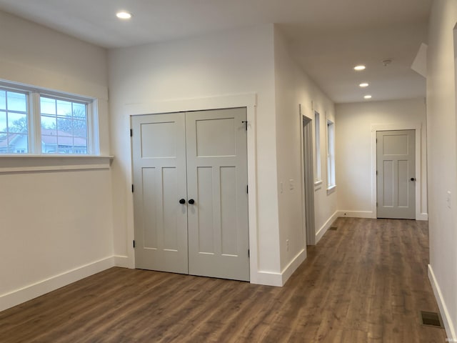 hallway with dark wood-type flooring