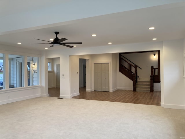 empty room with ceiling fan and carpet floors