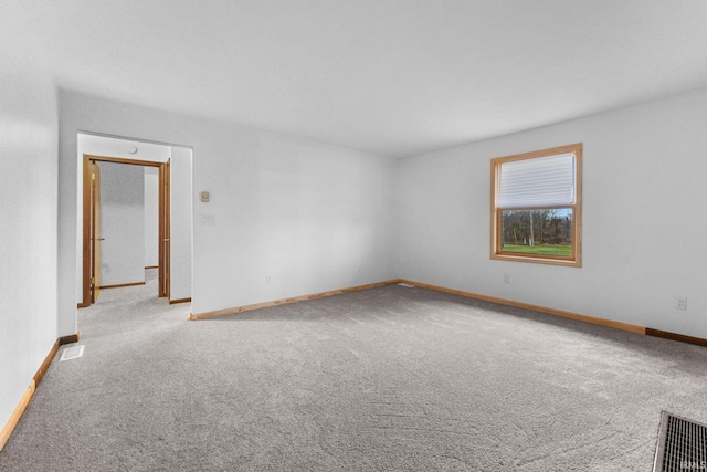 unfurnished room featuring light colored carpet