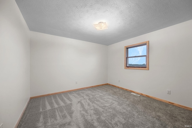 empty room featuring carpet floors and a textured ceiling