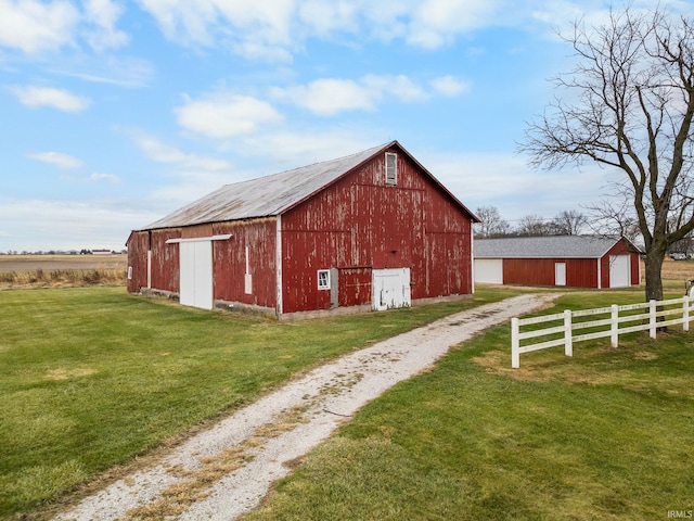 view of outbuilding featuring a yard and a rural view