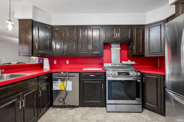 kitchen featuring dark brown cabinets, stainless steel appliances, hanging light fixtures, and sink