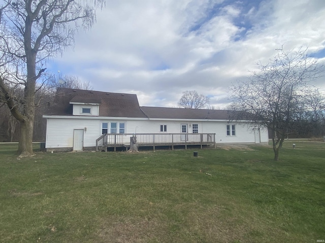 rear view of property with a deck and a lawn