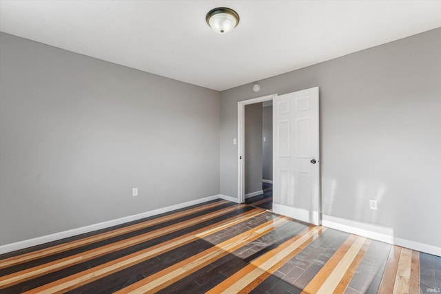 empty room with dark hardwood / wood-style floors