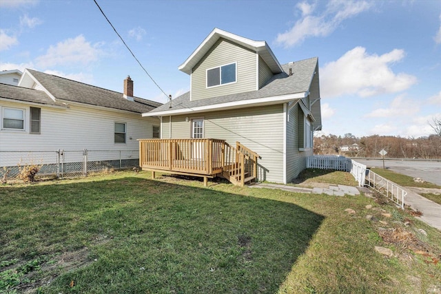 back of property with a lawn and a wooden deck