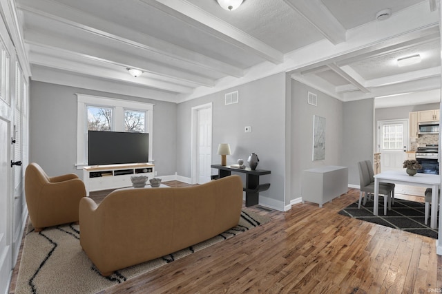 living room with beam ceiling and light hardwood / wood-style flooring