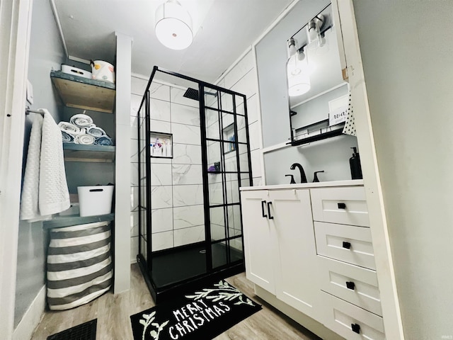 walk in closet with light hardwood / wood-style flooring and sink