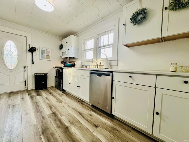 kitchen with stainless steel dishwasher, black / electric stove, crown molding, white cabinets, and light wood-type flooring