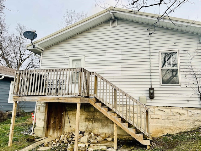 view of home's exterior featuring a wooden deck