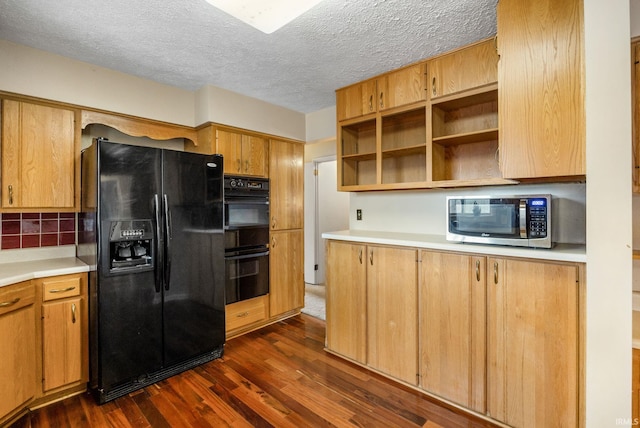 kitchen featuring a textured ceiling, tasteful backsplash, dark wood-type flooring, and black appliances