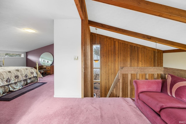 carpeted bedroom featuring vaulted ceiling with beams, wood walls, and multiple windows