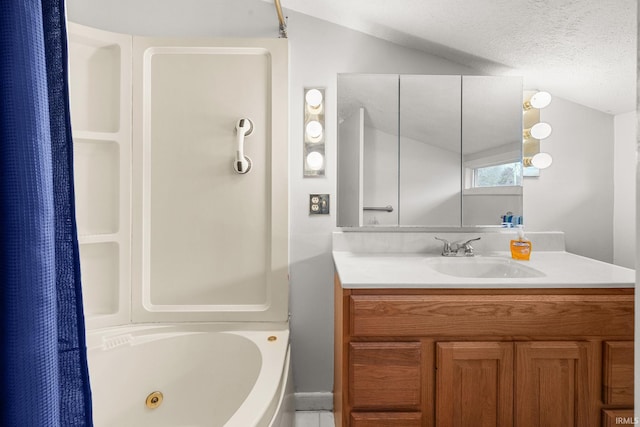 bathroom featuring vanity, a textured ceiling, and vaulted ceiling